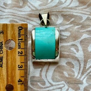 Turquoise pendant set in silver.